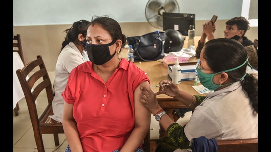 A medical worker administers a dose of COVID-19 vaccine to a woman at K D Singh Babu Stadium in Lucknow. (PTI) A medical worker administers a dose of COVID-19 vaccine to a woman at K D Singh Babu Stadium in Lucknow. (PTI)