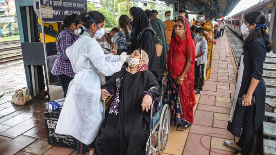A medic collects nasal sample from a passenger for Covid-19 testing at Dadar station in Mumbai. (PTI) A medic collects nasal sample from a passenger for Covid-19 testing at Dadar station in Mumbai. (PTI)