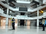 Workers clean and sanitize South City Mall ahead of its re-opening with certain restrictions, during ongoing Covid-induced lockdown, in Kolkata. (PTI) Workers clean and sanitize South City Mall ahead of its re-opening with certain restrictions, during ongoing Covid-induced lockdown, in Kolkata. (PTI)