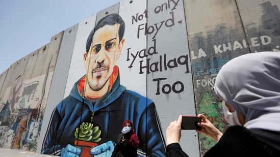Israeli barrier with a mural depicting Eyad al-Halaq, an unarmed and autistic Palestinian who was shot dead by Israeli police in West Bank. (Reuters)