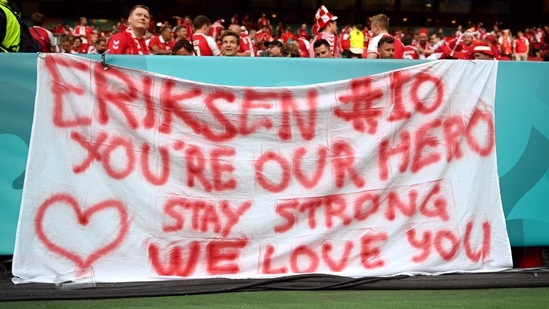 Denmark fans in the stands with a banner for Cristian Eriksen. (Pool via REUTERS)