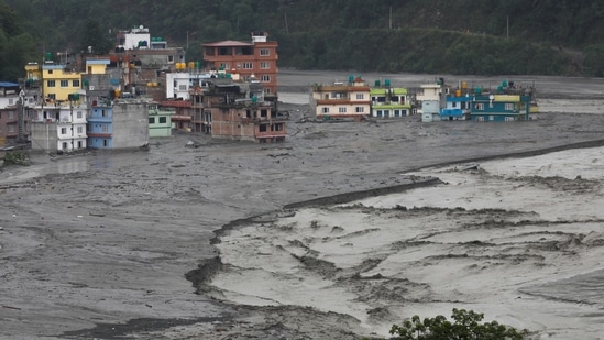 A view of houses hit by flash floods along the bank of Melamchi River in Sindhupalchok, on June 16. Melamchi town, once a brimming marketplace and centre of attraction, now remains submerged in a thick layer of mud, sand and water after the flood.(Navesh Chitrakar / REUTERS)