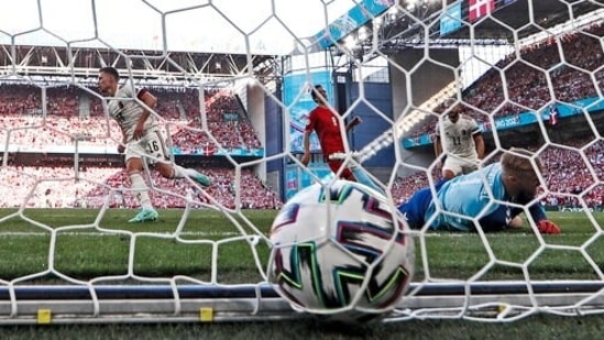 Belgium's Thorgan Hazard, left, scores his side's first goal against Denmark's goalkeeper Kasper Schmeichel , right, during the Euro 2020 soccer championship group B match.(AP)