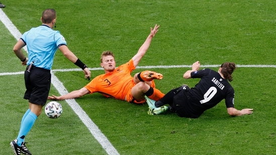 Matthijs de Ligt of the Netherlands, left, fights for the ball with Austria's Marcel Sabitzer. (AP) Matthijs de Ligt of the Netherlands, left, fights for the ball with Austria's Marcel Sabitzer. (AP)