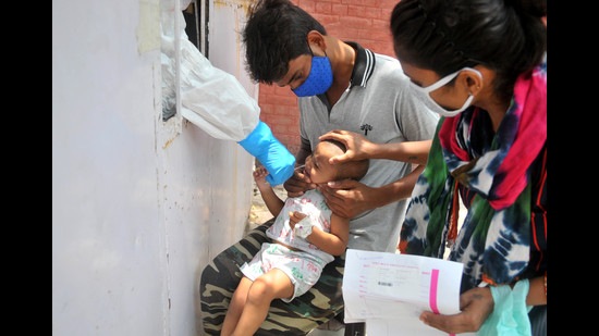 A health worker testing a child for Covid at the Sector-45 Civil Hospital in Chandigarh on Thursday. (Ravi Kumar/HT)