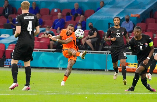 Memphis Depay, second from left, kicks the ball during the Euro 2020 soccer championship group C match between The Netherlands and Austria.