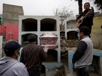 A relative of Marco Antonio Carillo, 48, who died of Covid-19 according to his family, plays the guitar during his burial at the "Martires 19 de Julio" cemetery on June 1 in Lima, Peru. Deaths from the coronavirus have exceeded 4 million as on June 17, Reuters reported citing a tally by the news agency.