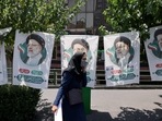 An Iranian woman walks past banners of ultraconservative cleric and presidential candidate Ebrahim Raisi, in Tehran, on June 17, 2021, on the eve of the Islamic republic's presidential election. (Photo by ATTA KENARE / AFP)(AFP) An Iranian woman walks past banners of ultraconservative cleric and presidential candidate Ebrahim Raisi, in Tehran, on June 17, 2021, on the eve of the Islamic republic's presidential election. (Photo by ATTA KENARE / AFP)(AFP)