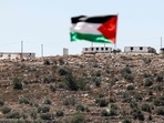 The flag of Palestine flutters on a rooftop across from the newly-built Israeli settler outpost in the village of Beita. The flag of Palestine flutters on a rooftop across from the newly-built Israeli settler outpost in the village of Beita.