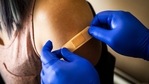 A healthcare places a band-aid on a patient after administering a dose of the Pfizer-BioNTech Covid-19 vaccine. (Bloomberg) A healthcare places a band-aid on a patient after administering a dose of the Pfizer-BioNTech Covid-19 vaccine. (Bloomberg)