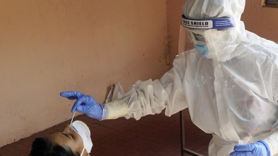 A health worker testing a woman for Covid-19 (ANI)