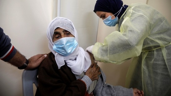 A Palestinian health worker gives a woman a dose of AstraZeneca vaccine against Covid-19 during a vaccination drive in Tubas, in the Israeli-occupied West Bank. (REUTERS FILE PHOTO)