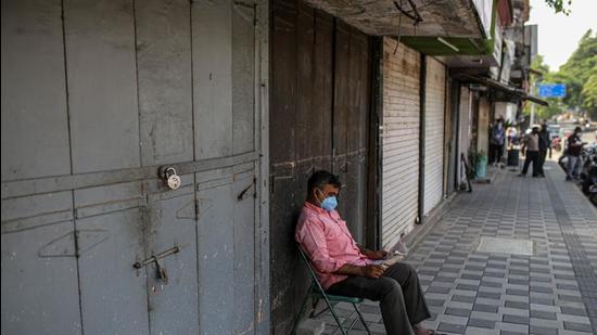 A man reads newspaper outside closed stores in Pune. (BLOOMBERG (FOR REPRESENTATIONAL PURPOSE ONLY)) A man reads newspaper outside closed stores in Pune. (BLOOMBERG (FOR REPRESENTATIONAL PURPOSE ONLY))