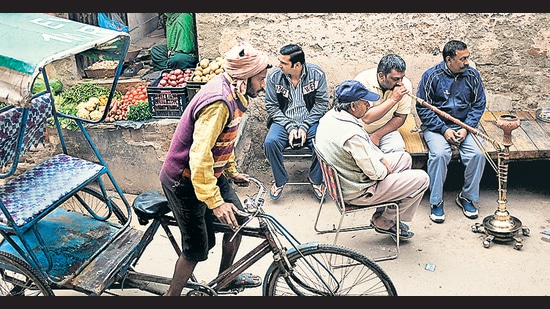 Men at a street corner. (Roberto Schimidt/AFP via Getty Images) Men at a street corner. (Roberto Schimidt/AFP via Getty Images)