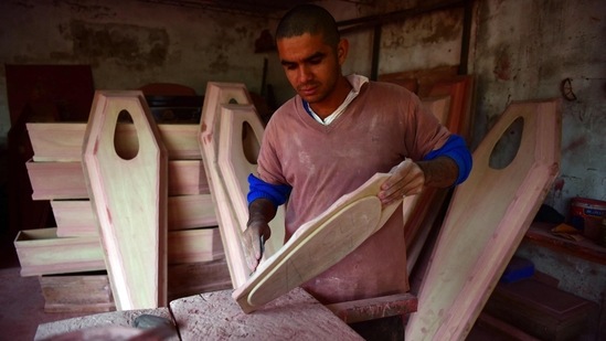 A carpenter builds coffins during the Covid-19 pandemic in San Lorenzo, Paraguay, on June 16. Countries in Latin America are facing their worst outbreak since March, with 43 of every 100 infections in the world being reported in the region, according to a Reuters analysis. The top nine countries reporting the most deaths per capita over the last week were all in Latin America.(Norberto Duarte / AFP)