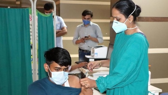 A medical professional administers an anti-Covid vaccine to a youth at Rohtak PGIMS. (HT file)