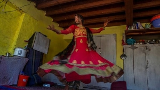 A transgender Kashmiri Maliaka Sheikh, in tradition attire of Kashmiri dancers, poses for photographs inside the home of a friend on the outskirts of Srinagar, Kashmir, Thursday, June 3, 2021. The 22-year-old transgender left home as an 11-year-old and started living with other transgenders. "At the beginning it was difficult for my family to understand me but fortunately, they have now accepted me for who I am," Maliaka said. (AP) A transgender Kashmiri Maliaka Sheikh, in tradition attire of Kashmiri dancers, poses for photographs inside the home of a friend on the outskirts of Srinagar, Kashmir, Thursday, June 3, 2021. The 22-year-old transgender left home as an 11-year-old and started living with other transgenders. "At the beginning it was difficult for my family to understand me but fortunately, they have now accepted me for who I am," Maliaka said. (AP)