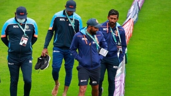 India's Mohammed Shami and Wriddhiman Saha walk with the members of team support staff along the boundary after the rain-delayed start of the first day of the World Test Championship final(AP)