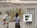 Park staff take pictures of a thermometer display showing temperatures of 130 Degrees Fahrenheit (54 Degrees Celsius) at the Furnace Creek Visitor's Center at Death Valley National Park in June 17 in Furnace Creek, California. Much of the western United States is braced for record heat waves this week, with approximately 50 million Americans placed on alert June 15 for 