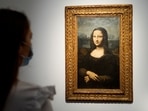 A woman looks at the Hekking "Mona Lisa", a reproduction of Leonardo Da Vinci's Mona Lisa, painted on canvas by an unknown artist from the 17th century and up for an online sale at Christie’s auction house in Paris, France.