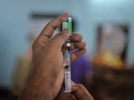 A health worker prepares to inoculate a beneficiary with a dose of the Covishield vaccine against the Covid-19 coronavirus, during a vaccine drive organized by the non-governmental organization (NGO) 'Anubhav' in Siliguri on June 17, 2021. (Photo by Diptendu DUTTA / AFP) A health worker prepares to inoculate a beneficiary with a dose of the Covishield vaccine against the Covid-19 coronavirus, during a vaccine drive organized by the non-governmental organization (NGO) 'Anubhav' in Siliguri on June 17, 2021. (Photo by Diptendu DUTTA / AFP)