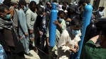 A man carries an oxygen cylinder from a privately owned oxygen factory, in Kabul, Afghanistan, as Covid surge worsens.(AP) A man carries an oxygen cylinder from a privately owned oxygen factory, in Kabul, Afghanistan, as Covid surge worsens.(AP)