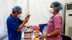 A health worker prepares a syringe with Covishield, Serum Institute of India's version of the AstraZeneca vaccine, during a drive-in vaccination program. (AP) A health worker prepares a syringe with Covishield, Serum Institute of India's version of the AstraZeneca vaccine, during a drive-in vaccination program. (AP)