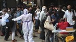 Health worker directs arriving passengers towards Covid-19 testing counter outside a train station in Bengaluru.(AP) Health worker directs arriving passengers towards Covid-19 testing counter outside a train station in Bengaluru.(AP)