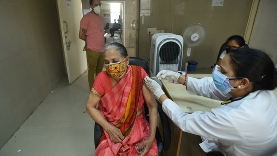 A health worker administers a Covid-19 vaccine at the sector 30 district hospital, in Noida, India, on Friday, June 18, 2021. (Photo by Sunil Ghosh / Hindustan Times)