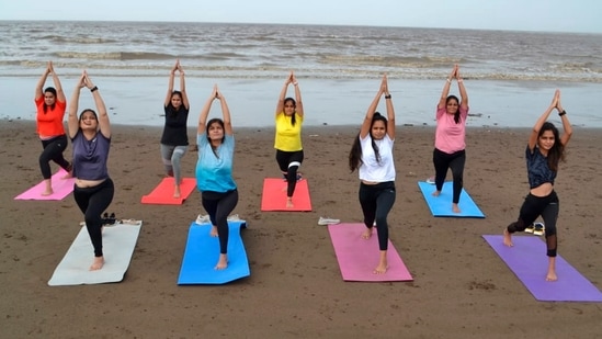 Surat: Women perform yoga on a beach ahead of International Yoga Day in Surat, Saturday, June 19, 2021. (PTI) Surat: Women perform yoga on a beach ahead of International Yoga Day in Surat, Saturday, June 19, 2021. (PTI)