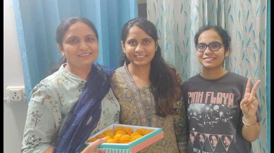 Navkiran Kaur celebrating her success with her family in Ludhiana. (HT Photo)