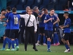 Italy coach Roberto Mancini speaks to players during the match against Switzerland.