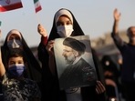 A supporter of Ebrahim Raisi displays his portrait during a celebratory rally for his presidential election victory in Tehran, Iran June 19, 2021. 