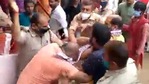 Three policemen seen surrounding the priest Amit Pandey as locals try to stop the clash. (LiveHindustan/Twitter) Three policemen seen surrounding the priest Amit Pandey as locals try to stop the clash. (LiveHindustan/Twitter)