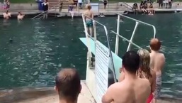 The image shows the kid standing in front of a swimming pool.
