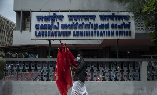 An activist of Centre of Indian Trade Unions (CITU) prepares to return after collecting the flags after a protest outside the Lakshadweep administration office in Kochi, Kerala(AP) An activist of Centre of Indian Trade Unions (CITU) prepares to return after collecting the flags after a protest outside the Lakshadweep administration office in Kochi, Kerala(AP)