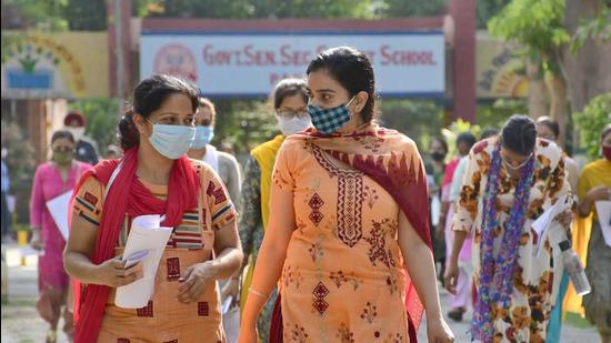 Candidates coming out from the examination centre at Government School in PAU, Ludhiana on Sunday. (Harsimar Pal Singh/HT)