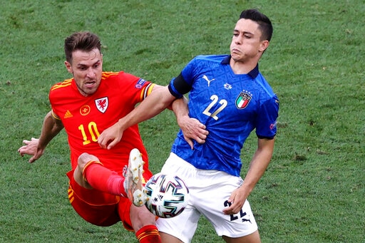 Wales' Aaron Ramsey, left, and Italy's Giacomo Raspadori challenge for the ball during the Euro 2020 soccer championship group A match between Italy and Wales at the Stadio Olimpico stadium in Rome, Sunday, June 20, 2021. (Ryan Pierse/Pool via AP) Wales' Aaron Ramsey, left, and Italy's Giacomo Raspadori challenge for the ball during the Euro 2020 soccer championship group A match between Italy and Wales at the Stadio Olimpico stadium in Rome, Sunday, June 20, 2021. (Ryan Pierse/Pool via AP)