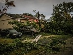 Fallen trees lay in front of a home after a tornado swept through the area in Woodridge, Ill., early Monday morning, June 21, 2021. Fallen trees lay in front of a home after a tornado swept through the area in Woodridge, Ill., early Monday morning, June 21, 2021.
