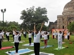 Participants, some wearing protective face masks against the coronavirus disease (Covid-19) outbreak, perform yoga during World Yoga Day in New Delhi.(REUTERS)