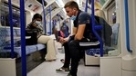 A commuter wearing aface covering due to Covid-19, but pulled down under their chins, sits in the carriage of a Transport for London (TFL) Underground Victoria Line train travelling out of central London on June 6, 2021.(AFP) A commuter wearing aface covering due to Covid-19, but pulled down under their chins, sits in the carriage of a Transport for London (TFL) Underground Victoria Line train travelling out of central London on June 6, 2021.(AFP)