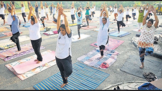 Fitness enthusiasts perform an asana to mark the International Day of Yoga at Sukhna Lake in Chandigarh on Monday. (Keshav Singh/HT) Fitness enthusiasts perform an asana to mark the International Day of Yoga at Sukhna Lake in Chandigarh on Monday. (Keshav Singh/HT)