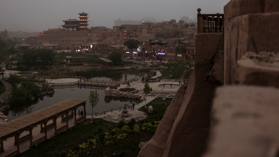 A Chinese pagoda overlooks the old city in Kashgar, Xinjiang Uyghur Autonomous Region, China on May 4. Some new attractions in southern Xinjiang are just a short drive away from the camps and prisons built to service Beijing's anti-extremism drive, Reuters reported. (Thomas Peter / REUTERS) A Chinese pagoda overlooks the old city in Kashgar, Xinjiang Uyghur Autonomous Region, China on May 4. Some new attractions in southern Xinjiang are just a short drive away from the camps and prisons built to service Beijing's anti-extremism drive, Reuters reported. (Thomas Peter / REUTERS)