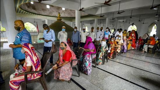 People wait to register themselves for a dose of Covid-19 vaccine during a drive at a mosque, in Ahmedabad on Monday, June 21. (PTI)