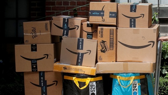 An Amazon delivery worker pulls a delivery cart full of packages during its annual Prime Day promotion in New York City, US. (Reuters)
