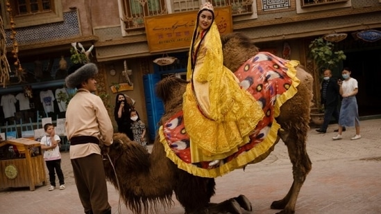 Performers in traditional clothes during a camel procession in the old city in Kashgar, Xinjiang Uyghur Autonomous Region, China on May 4. (Thomas Peter / REUTERS) Performers in traditional clothes during a camel procession in the old city in Kashgar, Xinjiang Uyghur Autonomous Region, China on May 4. (Thomas Peter / REUTERS)