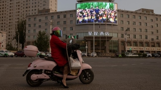 A screen shows a picture of President Xi Jinping standing among a crowd of smiling Uyghur children, at a traffic junction in Hotan, Xinjiang Uyghur Autonomous Region, China, on April 30. Murals on the walls of houses in one small village outside Hotan warned against the evils of extremism and depict happy mixed Uyghur and Han families, Reuters reported. (Thomas Peter / REUTERS) A screen shows a picture of President Xi Jinping standing among a crowd of smiling Uyghur children, at a traffic junction in Hotan, Xinjiang Uyghur Autonomous Region, China, on April 30. Murals on the walls of houses in one small village outside Hotan warned against the evils of extremism and depict happy mixed Uyghur and Han families, Reuters reported. (Thomas Peter / REUTERS)