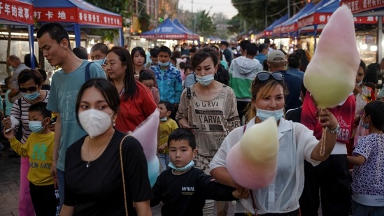 People walk in a night market during the May holidays tourist rush in the old city in Kashgar, Xinjiang Uyghur Autonomous Region, China,on May 2. The tourist drive is mostly targeted at domestic travellers, offering Xinjiang a new revenue source amid US sanctions. China expects more than 200 million visitors to Xinjiang this year and 400 million by 2025, from 158 million last year, Reuters reported. (Thomas Peter / REUTERS) People walk in a night market during the May holidays tourist rush in the old city in Kashgar, Xinjiang Uyghur Autonomous Region, China,on May 2. The tourist drive is mostly targeted at domestic travellers, offering Xinjiang a new revenue source amid US sanctions. China expects more than 200 million visitors to Xinjiang this year and 400 million by 2025, from 158 million last year, Reuters reported. (Thomas Peter / REUTERS)