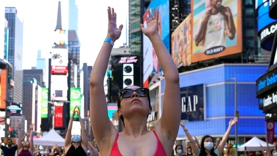 Yogis take part as Times Square Alliance hosts Solstice in Times Square: Mind Over Madness Yoga, (AFP)
