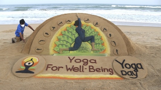 Sand artist Sudarsan Pattnaik creates a sand sculpture ahead of International Yoga Day, in Puri on Sunday. (PTI) Sand artist Sudarsan Pattnaik creates a sand sculpture ahead of International Yoga Day, in Puri on Sunday. (PTI)
